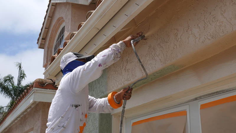 Professional Painter in Colorado painting a home